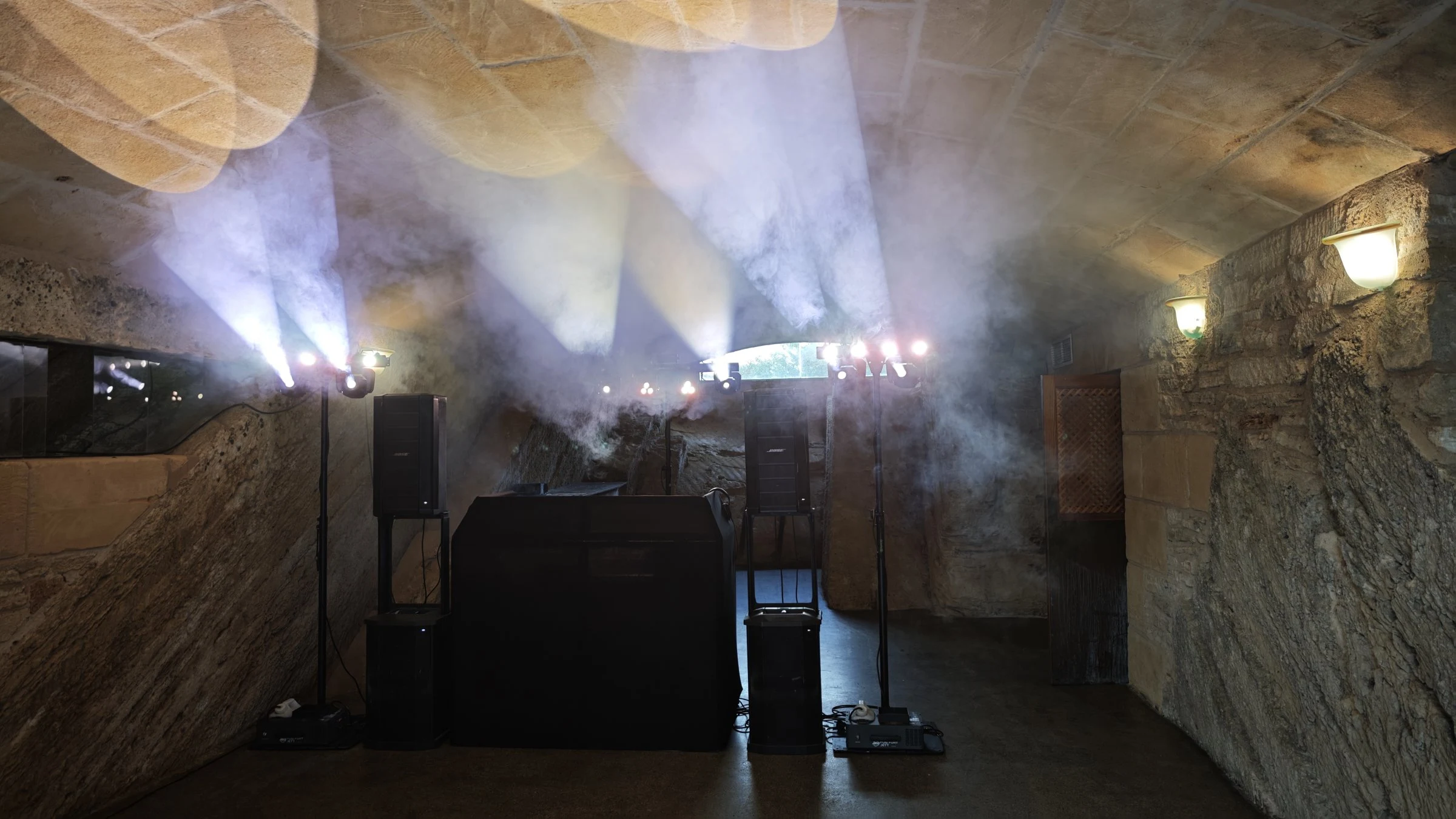 Party setup in a vaulted cellar with two BOSE F1, moving heads in the haze and DJ booth in Santa Margalida