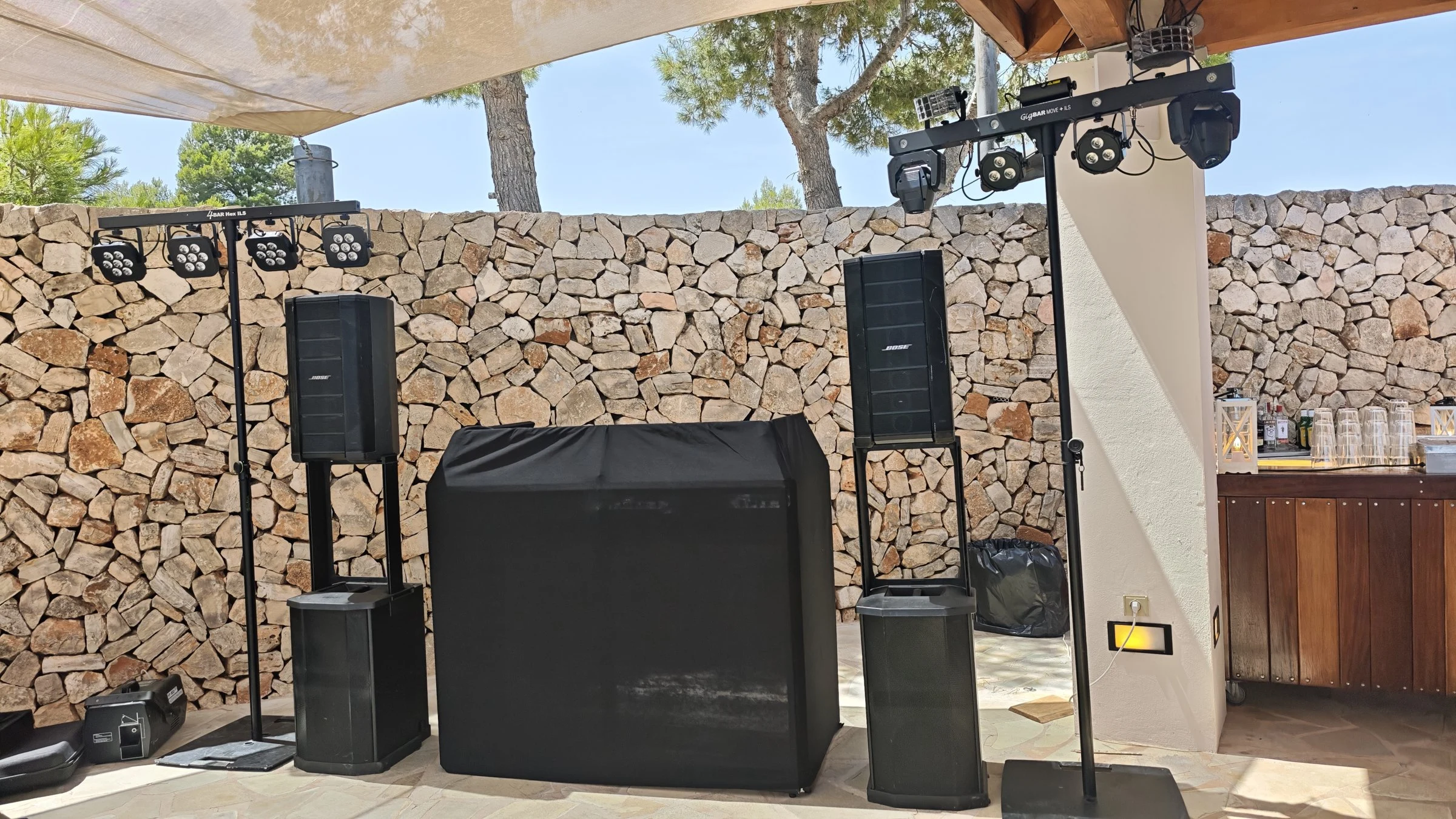 Outdoor setup under a sun sail with two BOSE F1 speakers, light bars and DJ booth in Felanitx